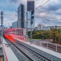Modern high-speed train moves on the business center background Royalty Free Stock Photo