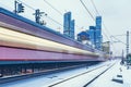 Modern high-speed train moves fast on the business center background Royalty Free Stock Photo