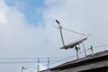 Modern high technology satellite on a roof with cloudy sky Royalty Free Stock Photo