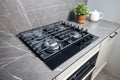 Modern hob gas stove made of tempered black glass using natural gas or propane for cooking products on light countertop Royalty Free Stock Photo