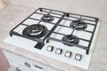 Modern hob gas stove made of tempered white glass using natural gas or propane for cooking products on light countertop Royalty Free Stock Photo