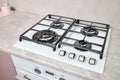 Modern hob gas stove made of tempered white glass using natural gas or propane for cooking products on light countertop Royalty Free Stock Photo