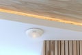 Modern home ceiling with smoke detector and wooden paneling design Royalty Free Stock Photo