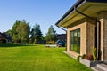 Modern house side yard with large garden window