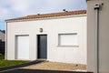 Modern home facade with entrance front door and closed windows shutter