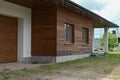 Modern home facade. Wall construction with insulating wood cladding. A new house with a garage Royalty Free Stock Photo