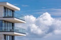 The modern home has a glass-railed balcony that overlooks a blue sky Royalty Free Stock Photo