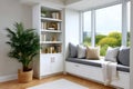 Cozy reading nook with window seat and bookcase Royalty Free Stock Photo