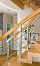 Modern home living room area with wooden stairs Royalty Free Stock Photo