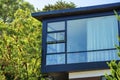 Modern home with large panoramic window and box like design with flat roof and box shape in late afternoon sun Royalty Free Stock Photo