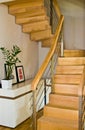 Modern home living room area with wooden stairs Royalty Free Stock Photo