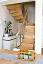 Modern home living room area with wooden stairs Royalty Free Stock Photo