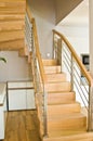 Modern home living room area with wooden stairs Royalty Free Stock Photo