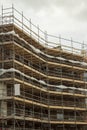 Modern home of office building construction with scaffolding. Cloudy sky background. New house development. Construction industry Royalty Free Stock Photo