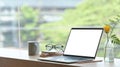 Modern home office with computer laptop, books, coffee cup and glasses on wooden table. Royalty Free Stock Photo