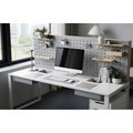 Modern home office desk setup with pegboard organization and computer Royalty Free Stock Photo