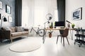 Modern home office interior with a big window, sofa, bike and de Royalty Free Stock Photo