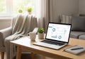 Modern home office setting with a laptop displaying analytical graphs and charts. The laptop sits Royalty Free Stock Photo