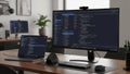 Modern home office setup with dual monitors and coding screen Royalty Free Stock Photo