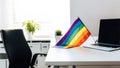 A modern home office setup with laptop and a rainbow flag on desk, for pride day. Generative AI. Royalty Free Stock Photo