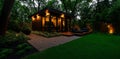modern home office shed with large windows, surrounded by lush greenery and illuminated at night, creating cozy and inviting Royalty Free Stock Photo