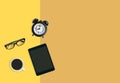 Modern home office workplace concept, Alarm clock, Coffee, eyeglasses and tablet yellow background