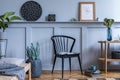 Modern home staging of living room with design chair, wooden console, mock up poster map.