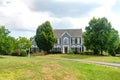 Modern home villa front luxury large home. cottage with green lawn. Asphalt driveway and blue sky Royalty Free Stock Photo