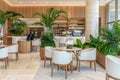 Modern Hotel Lobby With Cafe, Reception, And Stylish Greenery Design. Upscale Hospitality Interior Royalty Free Stock Photo