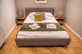 Modern hotelroom queensize bed on wooden floor