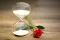 Modern hourglass and red rose with copy space. Royalty Free Stock Photo