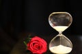 Modern hourglass and red rose with copy space. Royalty Free Stock Photo