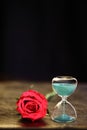 Modern hourglass and red rose with copy space. Royalty Free Stock Photo