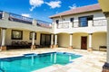 Modern House with blue sky and green grass with a water fountain