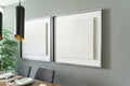 Modern decoration, empty silver square frame, poster, white canvas, mock up, on a gray wall, dining room, painting gallery Royalty Free Stock Photo