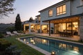 Modern house at dusk with swimming pool and barbecue in backyard Royalty Free Stock Photo