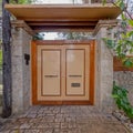 A modern house external entrance wooden door and stonewalls Royalty Free Stock Photo