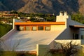 Modern house facade with white stucco and wood exterior and orange accent paint with slanted flat roof and windows Royalty Free Stock Photo