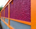 Modern house fence with purple and orange color combination. Royalty Free Stock Photo