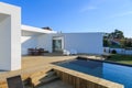 Modern house with garden swimming pool and wooden deck Royalty Free Stock Photo