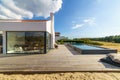 Modern house with garden swimming pool and wooden deck Royalty Free Stock Photo