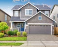 Modern house with gray exterior, and blue white trim. Royalty Free Stock Photo