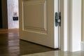 Modern house interior detail with wooden parquet floor and white door. Apartment after renovation close-up. Royalty Free Stock Photo