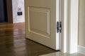 Modern house interior detail with wooden parquet floor and white door. Apartment after renovation close-up. Royalty Free Stock Photo