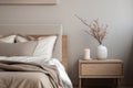 Modern house interior details. Simple cozy beige bedroom interior with bed headboard, linen bedding, bedside table and Royalty Free Stock Photo