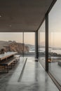A modern house with a large glass window looking out onto the ocean Royalty Free Stock Photo
