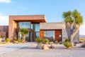 Modern house located in desert with clear sky and palm trees under bright sunlight Royalty Free Stock Photo