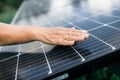 Modern house with solar panels. Close up of woman touching solar panels on the roof. Green energy concept. High quality Royalty Free Stock Photo