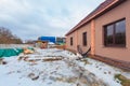 The modern house with terrace is under construction and construction material for renovation are outside Royalty Free Stock Photo