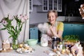 Modern housewife cooks in the kitchen. portrait of a woman cook with mixer. Preparing for Easter Royalty Free Stock Photo